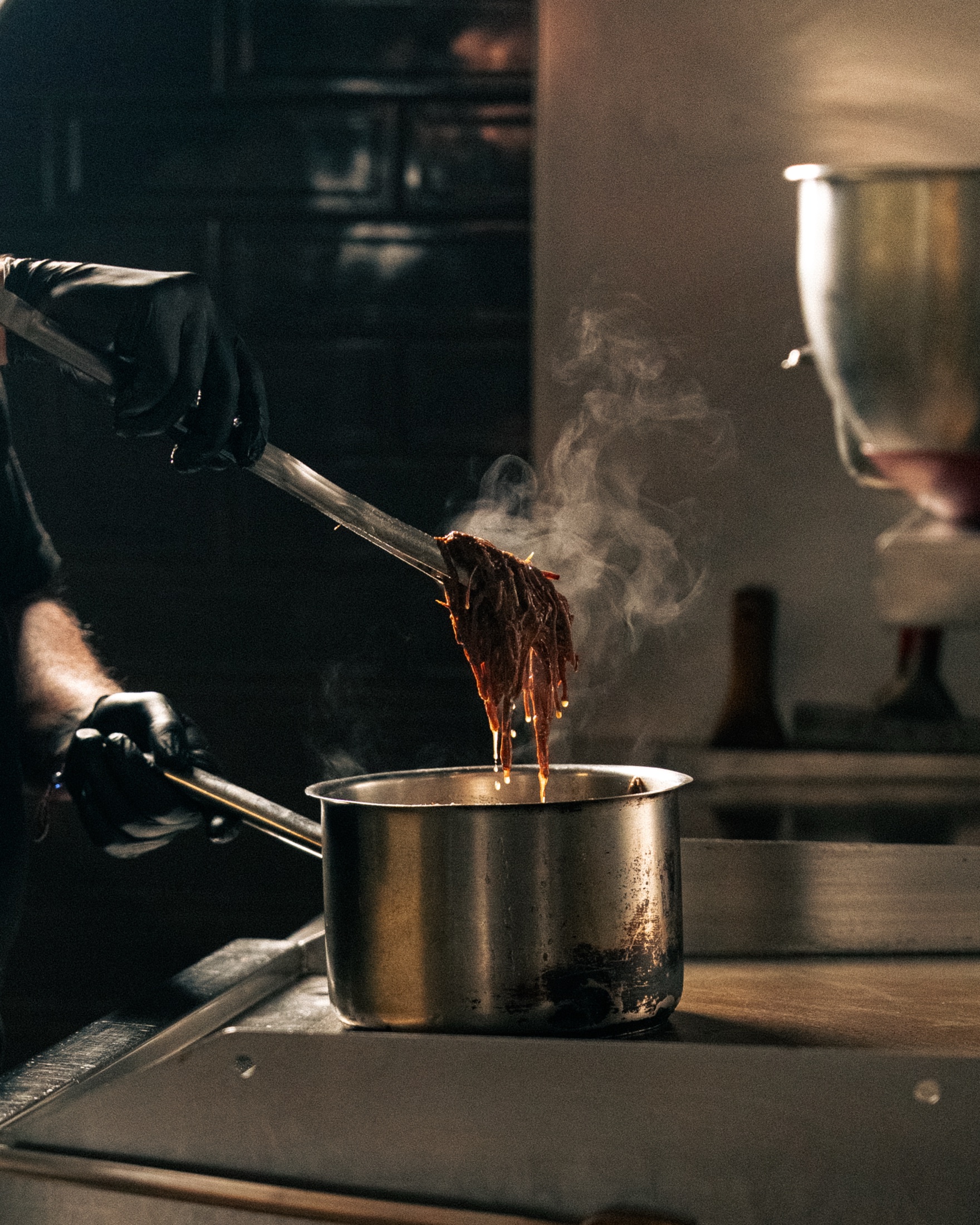 Slow-cooked beef being prepared in the Mahalle Burger kitchen