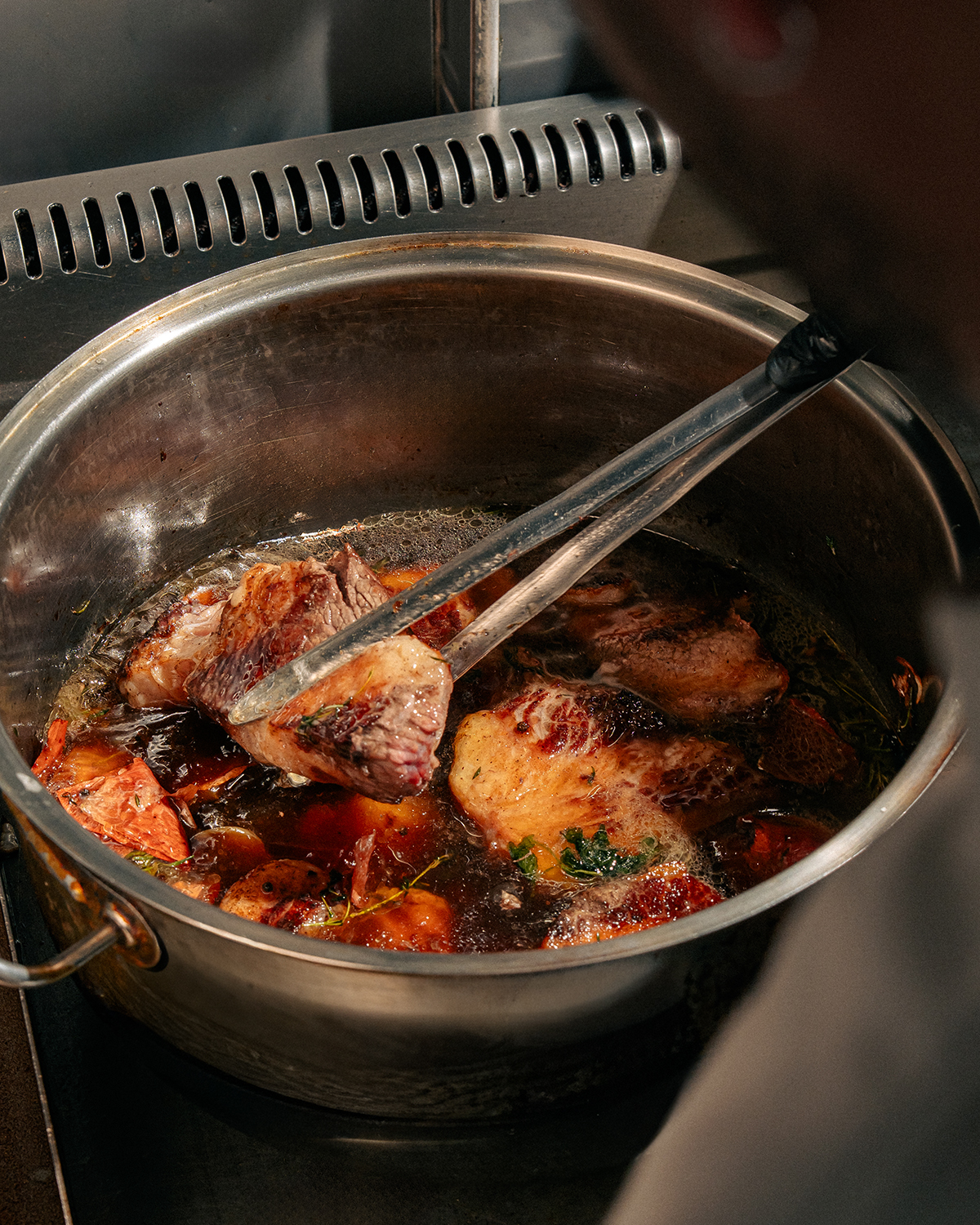 Mahalle Burger kitchen preparation with slow-cooked meat