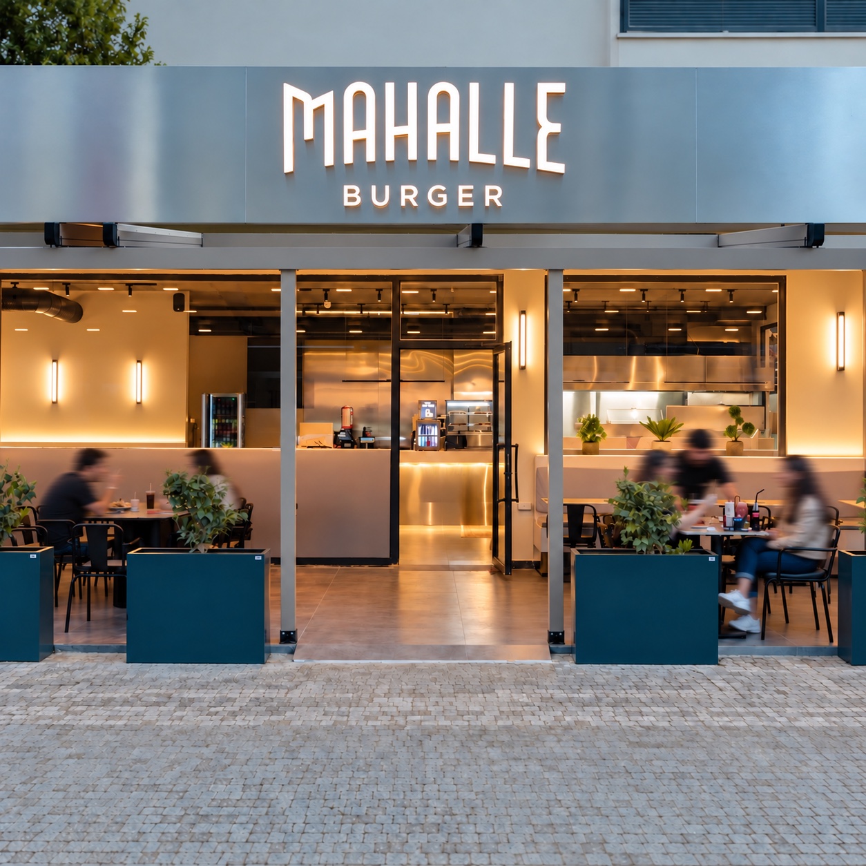 Mahmutlar Mahalle Burger’de masalarda oturan misafirler ve onlarla ilgilenen ekip